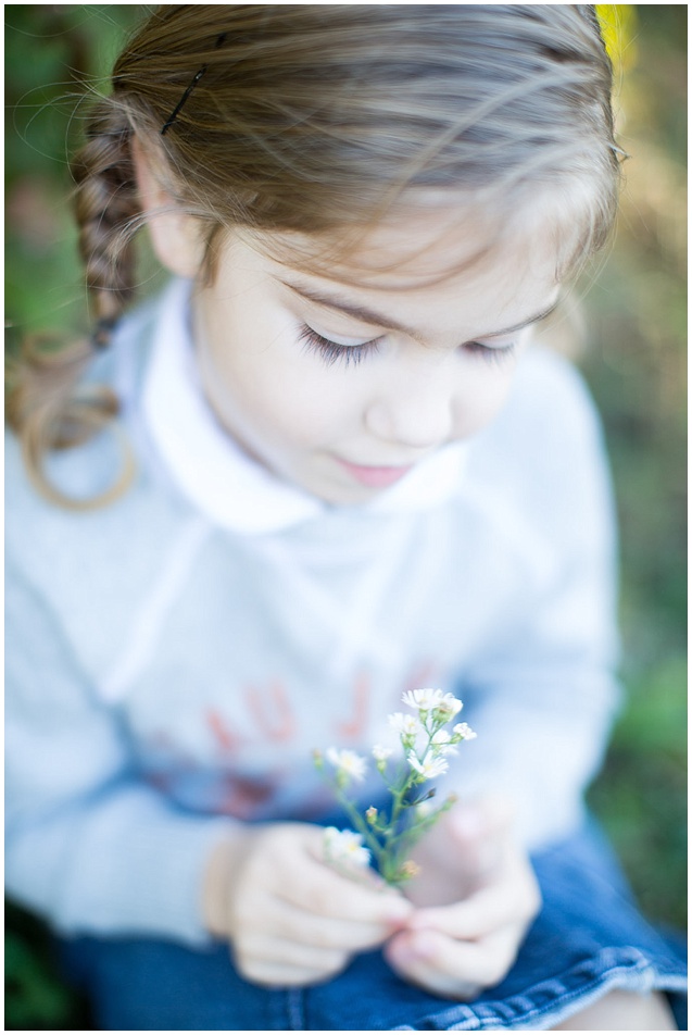 2. Distractions. I try not to focus on my camera during a photo session. It's different and scary at times to a small child. I usually ask them about things that are around them. This image the little girls was talking about the flowers she found in the field. So precious. 