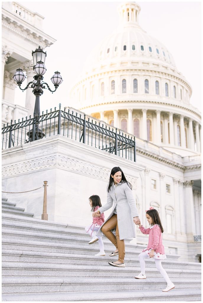 mother and two little girls walking up the Capitol steps 