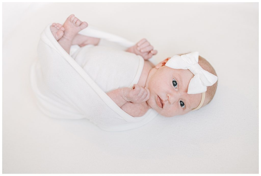 newborn girl in white swaddle 