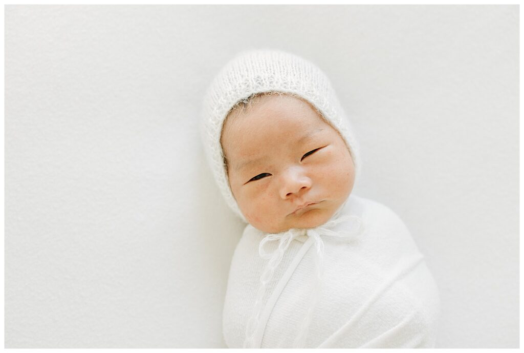 baby with white bonnet 