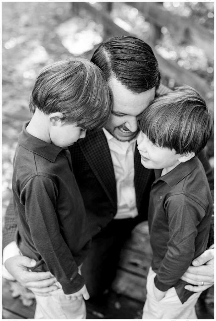 dad hugging two little boys 