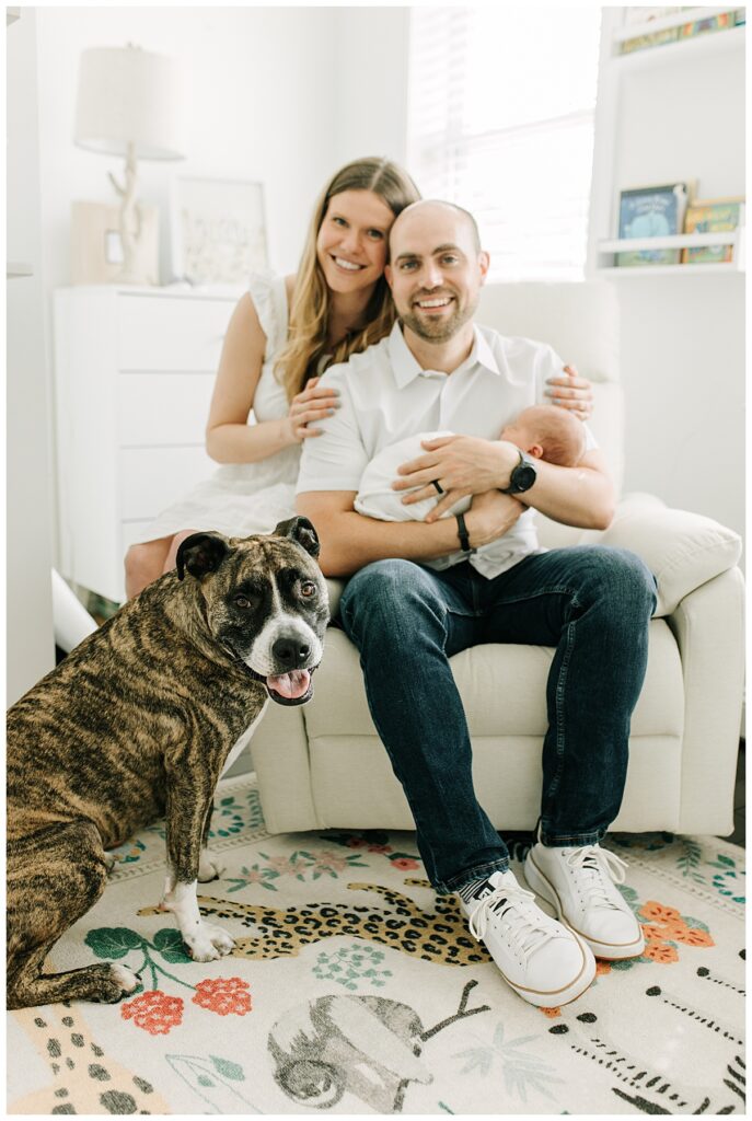 new parents with their baby boy and dog 