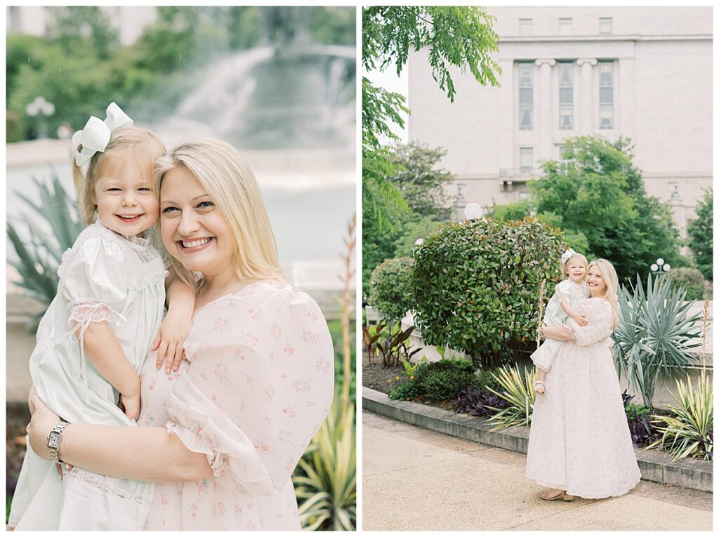 mother and daughter hugging in front of fountain 