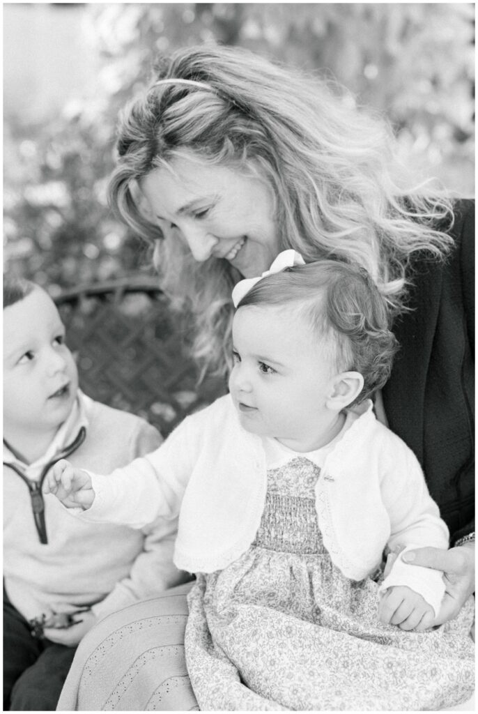 grandmother smiling with her two grandchildren 