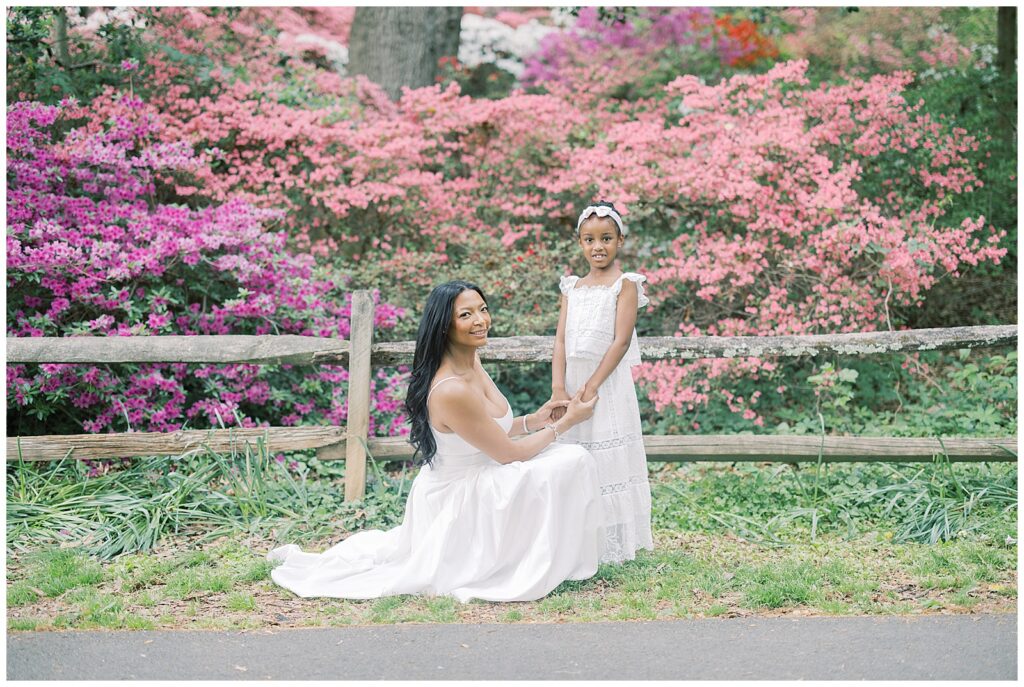 mother and daughter in white dresses and pink azaleas