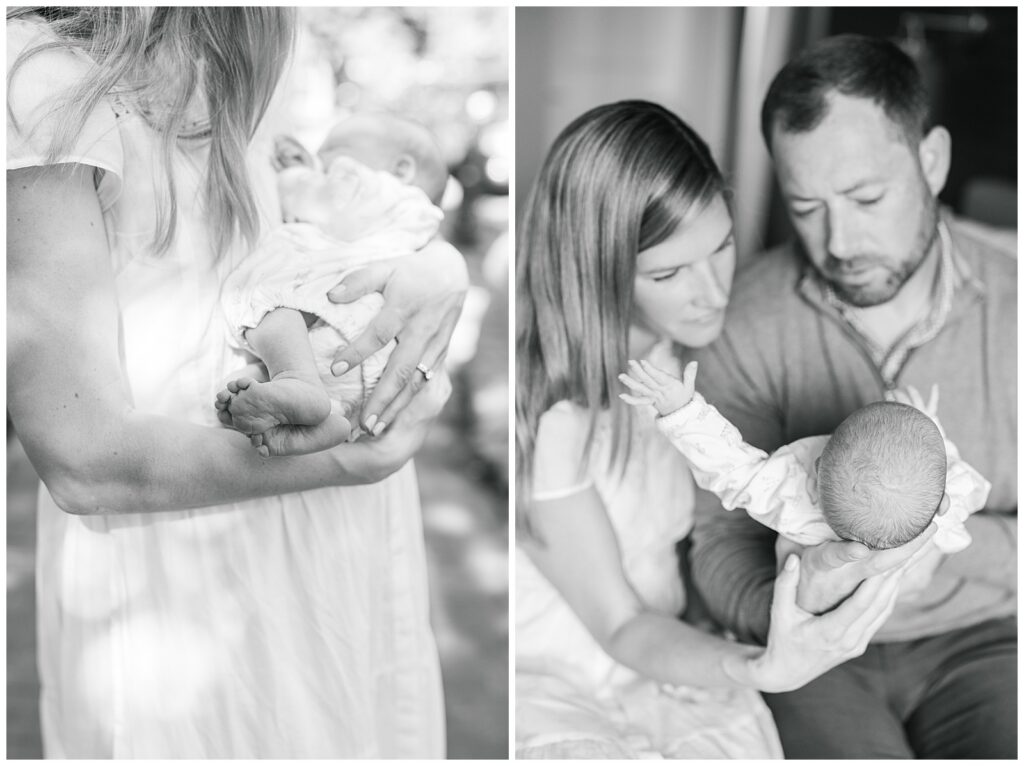 mother and dad looking at newborn daughter in black and white photograph 