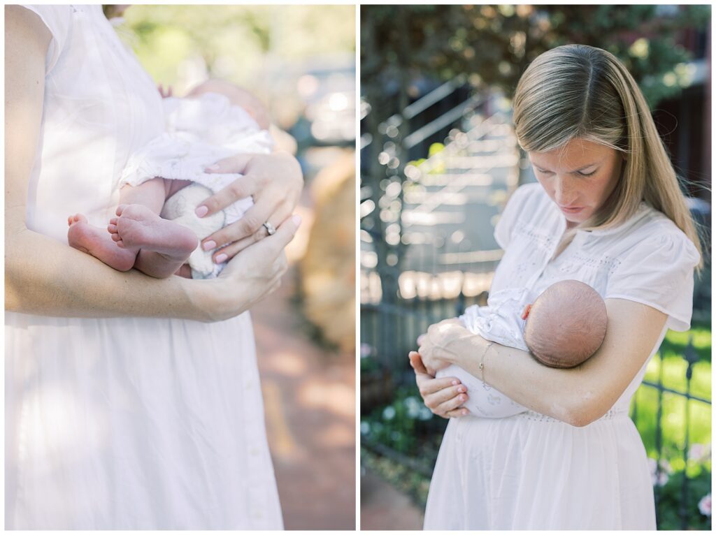 mother standing on the sidewalk in the city soothing her baby girl 